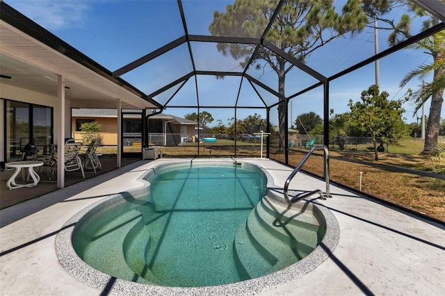 view of pool featuring glass enclosure and a patio area