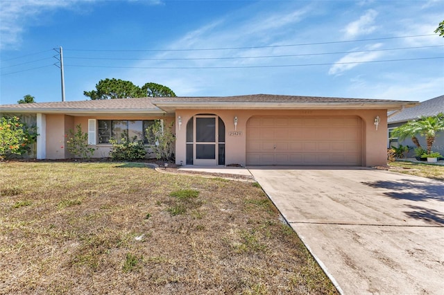 ranch-style house featuring a garage and a front lawn