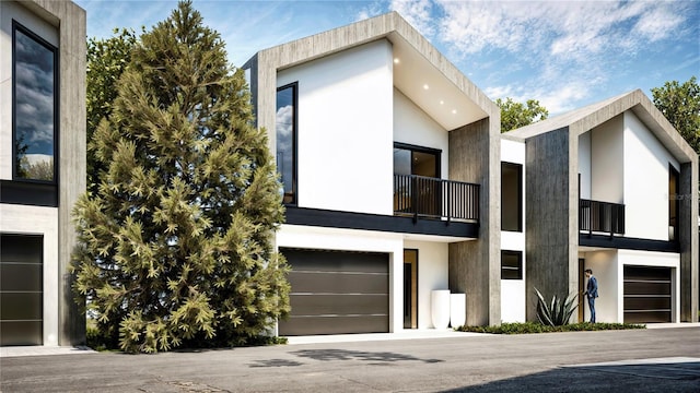 view of front of home with a garage and a balcony