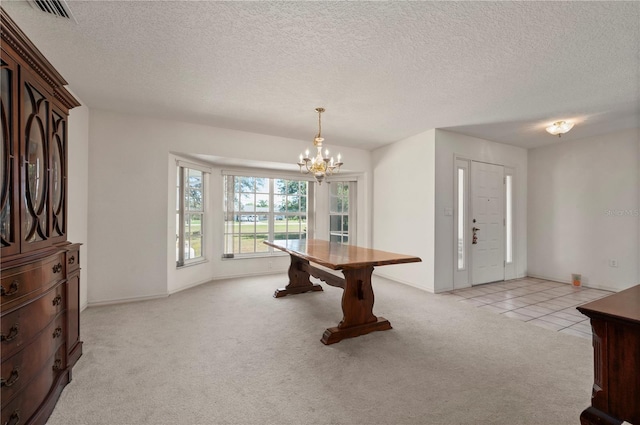 playroom with a chandelier, a textured ceiling, and light colored carpet