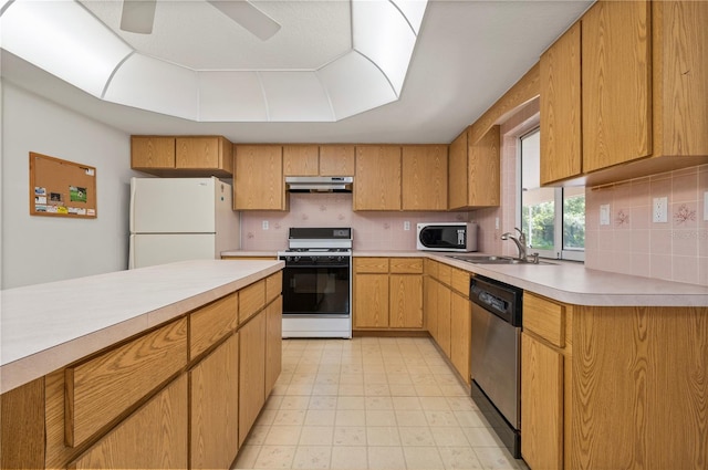 kitchen featuring backsplash, ceiling fan, white appliances, and sink