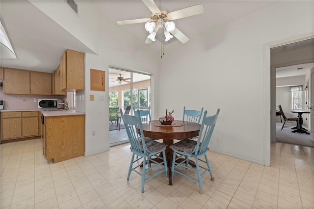 dining room featuring ceiling fan and sink