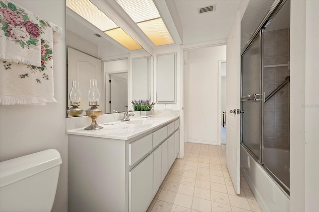 full bathroom featuring vanity, toilet, and enclosed tub / shower combo