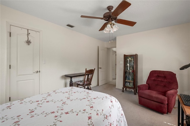 carpeted bedroom with ceiling fan and a closet