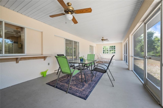 sunroom / solarium featuring ceiling fan