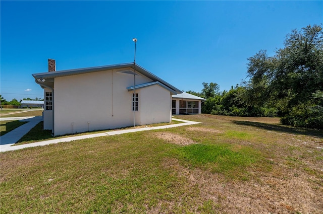 rear view of property with a yard