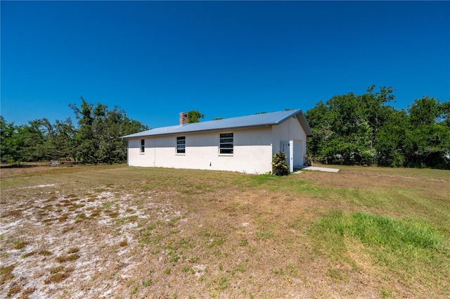 rear view of property with a yard