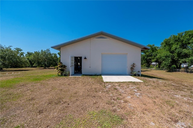 exterior space featuring a garage and a yard