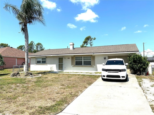 ranch-style house with a garage, driveway, a front lawn, and stucco siding