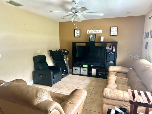 tiled living area featuring visible vents and a ceiling fan