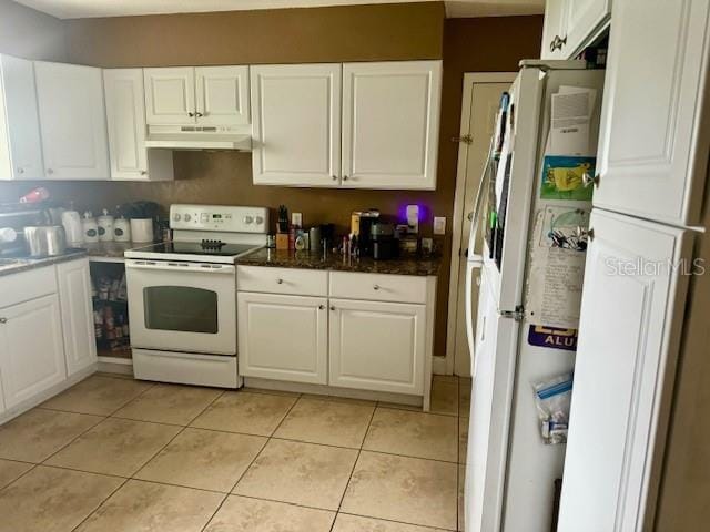 kitchen with white appliances, under cabinet range hood, white cabinetry, and light tile patterned floors