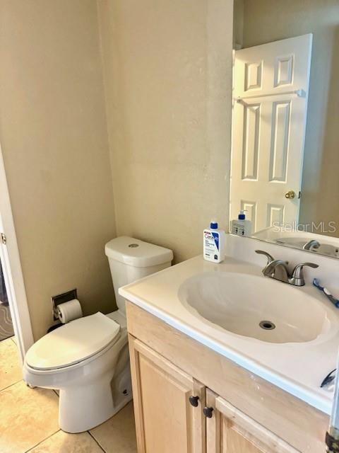 bathroom featuring vanity, toilet, and tile patterned floors