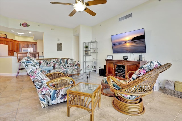 living room with ceiling fan and light tile patterned flooring