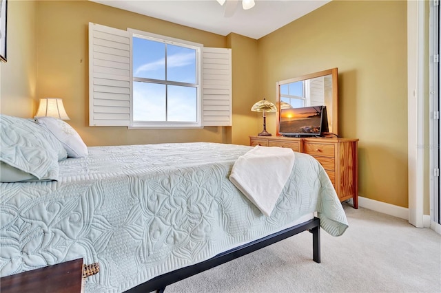 bedroom with ceiling fan and light colored carpet