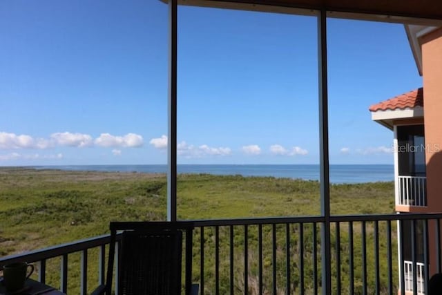 unfurnished sunroom with a water view