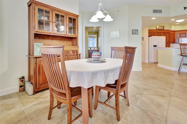 dining area featuring a chandelier and light tile patterned floors