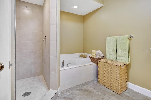 bathroom featuring plus walk in shower and tile patterned flooring