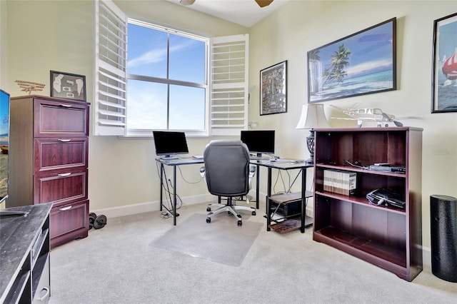 office area featuring light carpet and ceiling fan