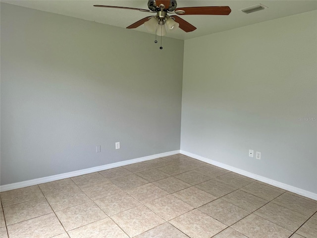 spare room with visible vents, ceiling fan, baseboards, and tile patterned floors