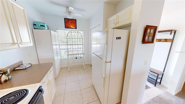 kitchen featuring white fridge, ceiling fan, and light tile patterned flooring