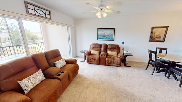 carpeted living room featuring ceiling fan