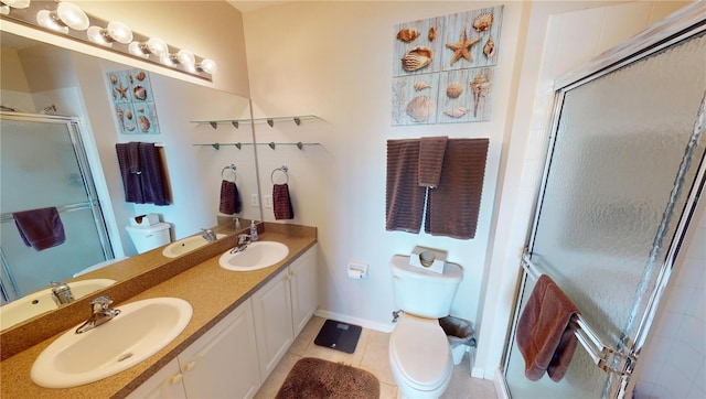 bathroom with tile patterned flooring, vanity, toilet, and walk in shower