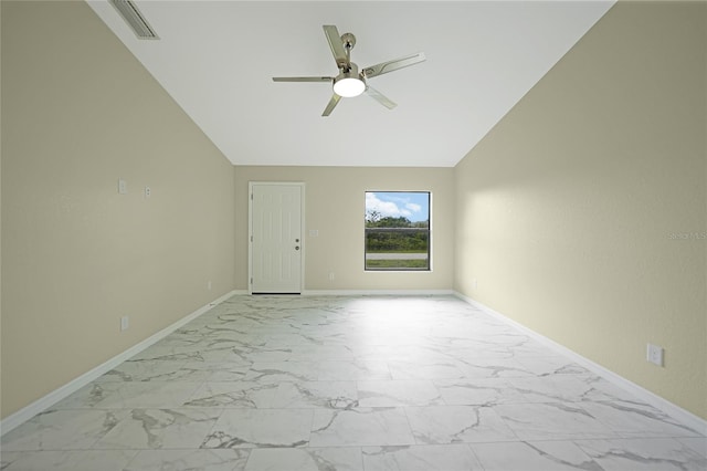 empty room featuring lofted ceiling, a ceiling fan, visible vents, baseboards, and marble finish floor