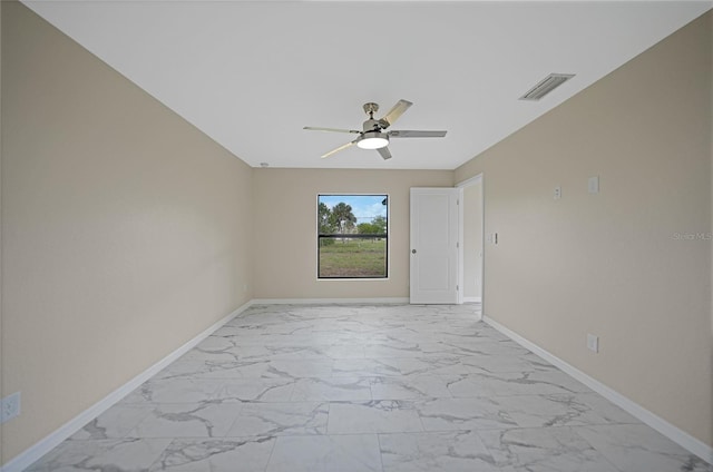 spare room featuring ceiling fan, marble finish floor, visible vents, and baseboards