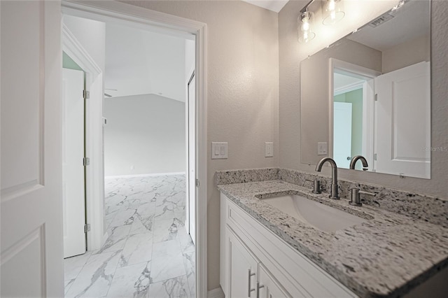 bathroom featuring marble finish floor and vanity