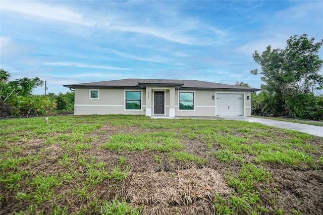 view of front of home featuring a front yard, driveway, an attached garage, and stucco siding