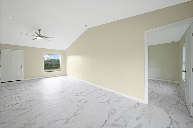 unfurnished room with marble finish floor, baseboards, vaulted ceiling, and a ceiling fan