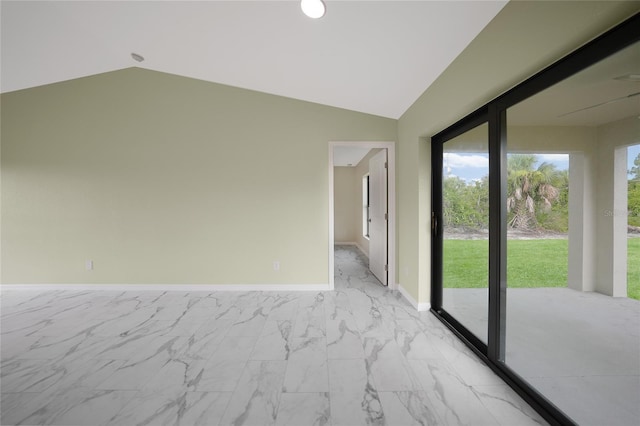 empty room featuring marble finish floor, baseboards, and vaulted ceiling