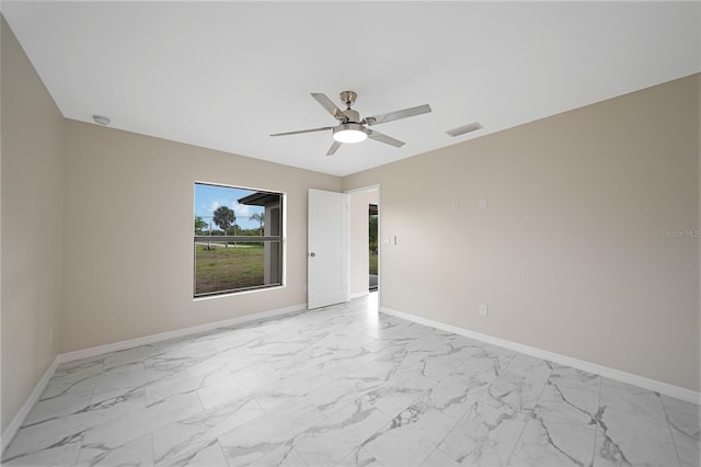 unfurnished room featuring marble finish floor, baseboards, and visible vents