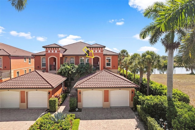 mediterranean / spanish-style home with a garage