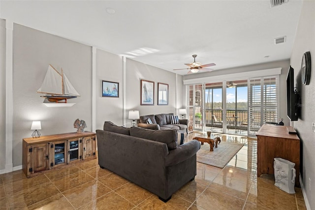 tiled living room featuring ceiling fan