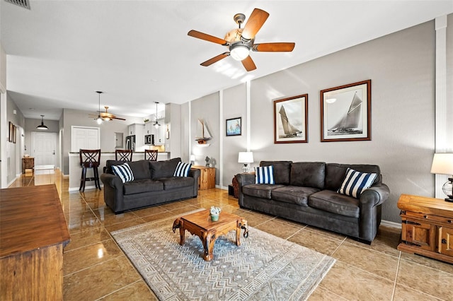 living room with tile patterned floors and ceiling fan