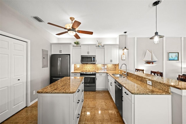 kitchen with white cabinets, sink, hanging light fixtures, and appliances with stainless steel finishes