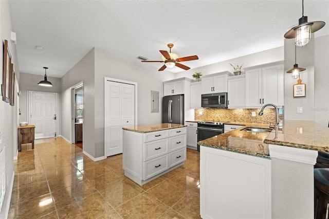 kitchen featuring pendant lighting, sink, kitchen peninsula, and stainless steel appliances