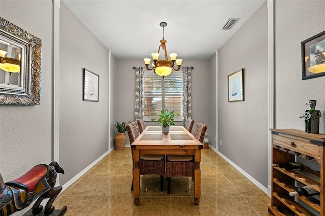 dining room featuring light tile patterned flooring and an inviting chandelier