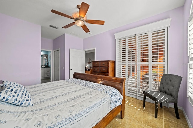 bedroom with light tile patterned floors, ensuite bath, and ceiling fan