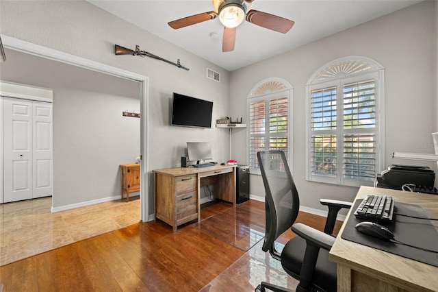 home office featuring ceiling fan and dark wood-type flooring