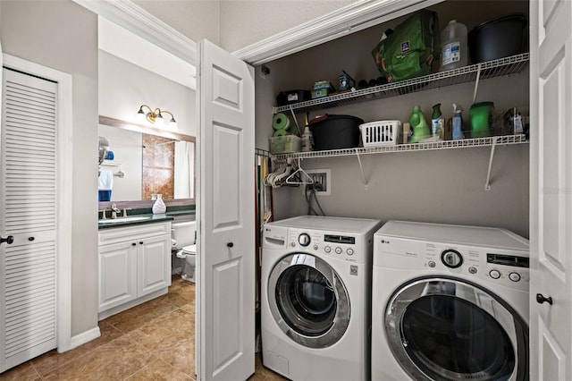 laundry area with sink, light tile patterned floors, washer and dryer, and ornamental molding