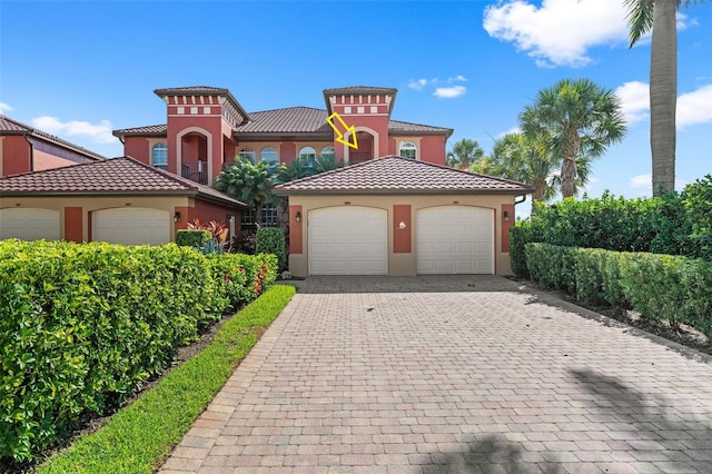 mediterranean / spanish house featuring a garage