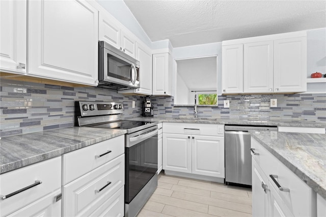 kitchen featuring white cabinets, sink, tasteful backsplash, and stainless steel appliances