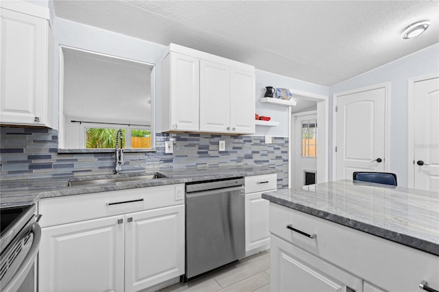 kitchen featuring white cabinets, tasteful backsplash, and dishwasher