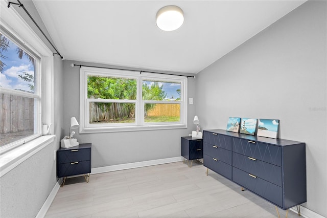 bedroom featuring light hardwood / wood-style flooring and lofted ceiling