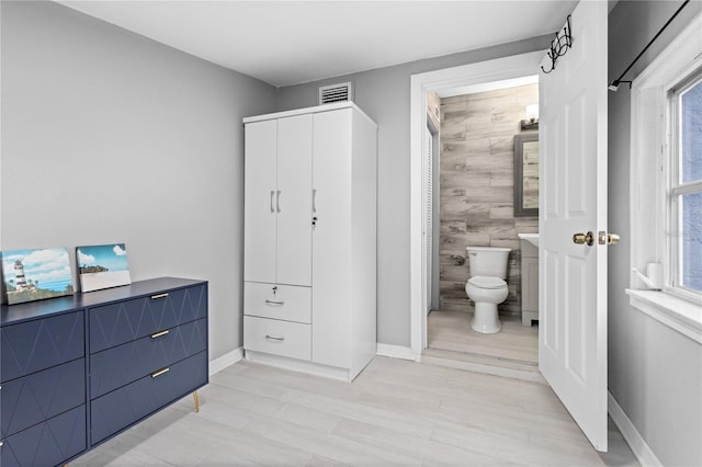 bathroom featuring hardwood / wood-style flooring and toilet