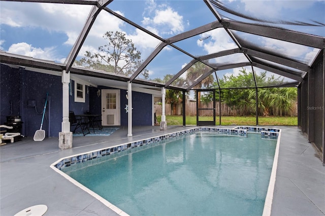 view of swimming pool featuring a patio and a lanai