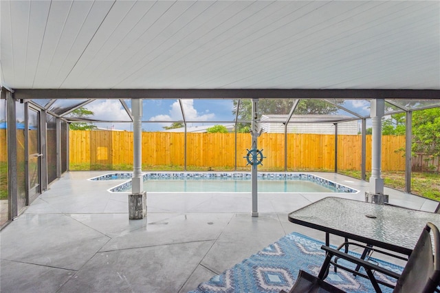 view of swimming pool with glass enclosure and a patio area