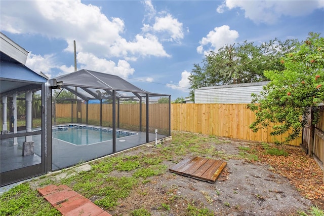 view of yard with glass enclosure and a fenced in pool